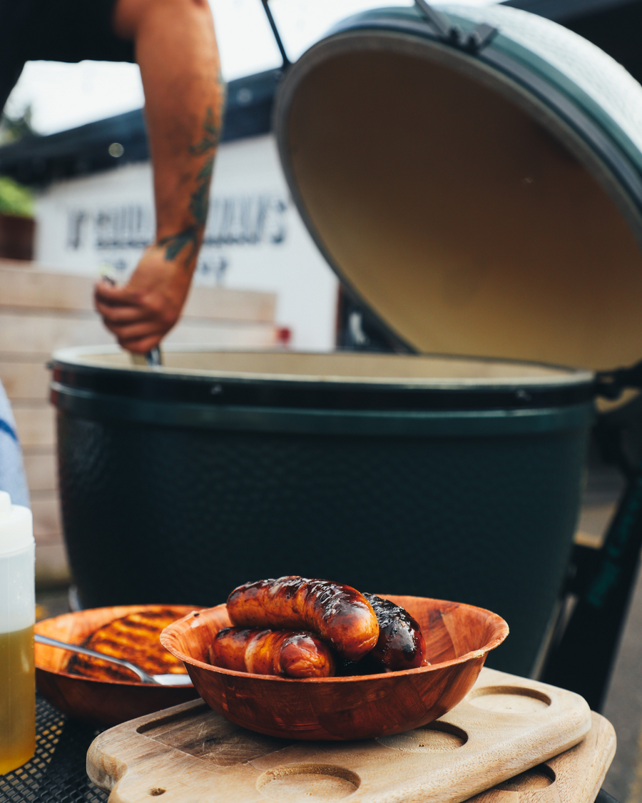 olympia provisions grilling sausages on green egg