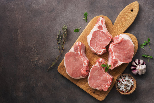 Raw Pork Chops on Board