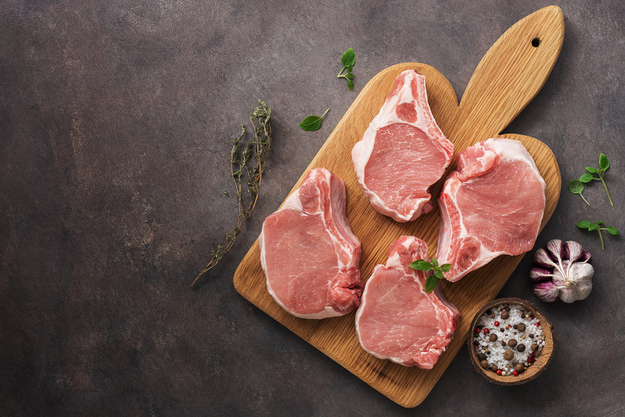 Raw Pork Chops on Board