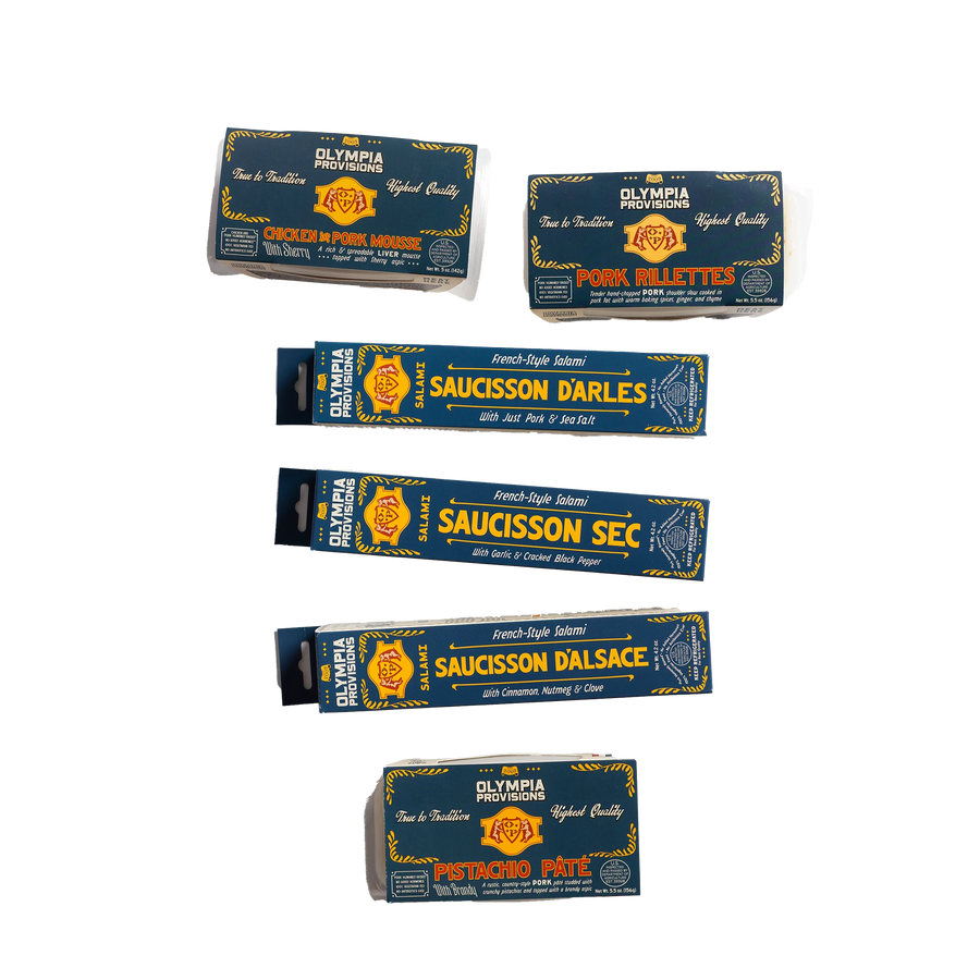 Three Olympia Provisions French salamis and artisan pates, all packaged in blue boxes.