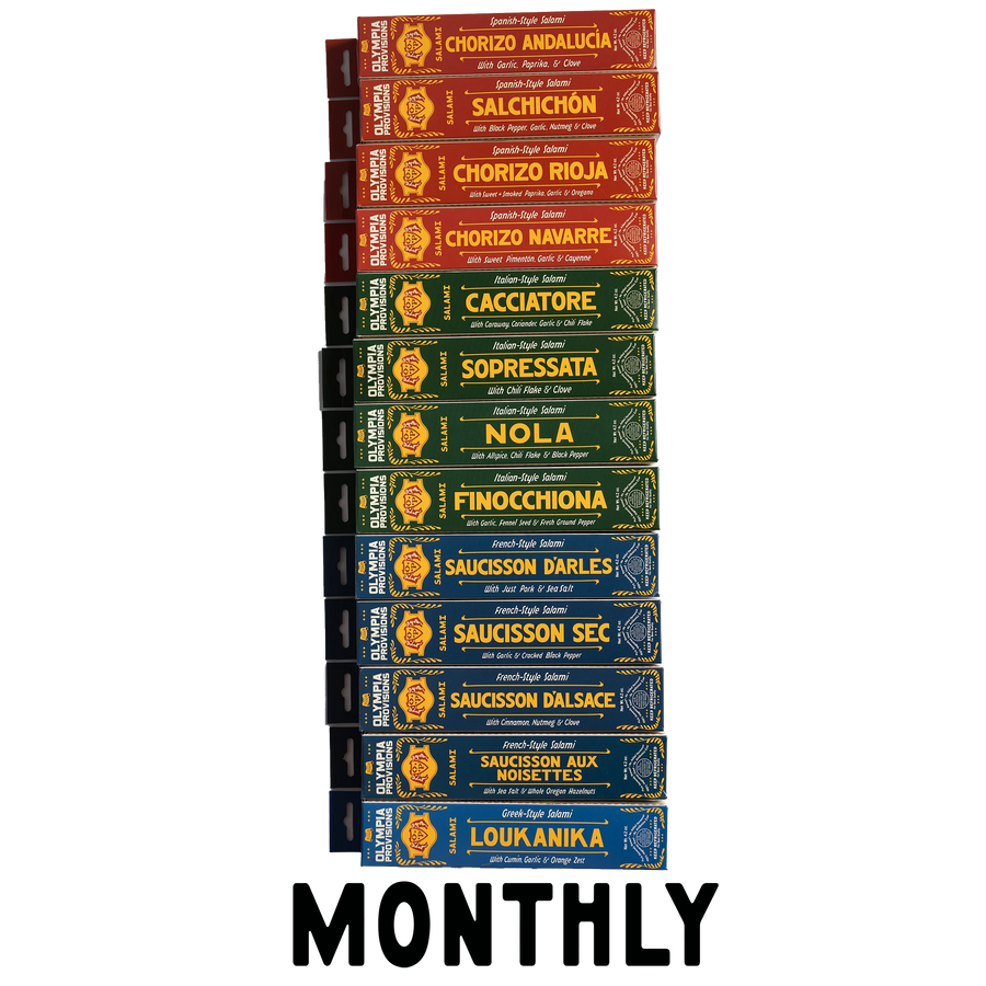 Vertical stack of 12 varied French, Spanish, Italian, and Greek Olympia Provisions Salami with the word "Monthly" at the bottom.
