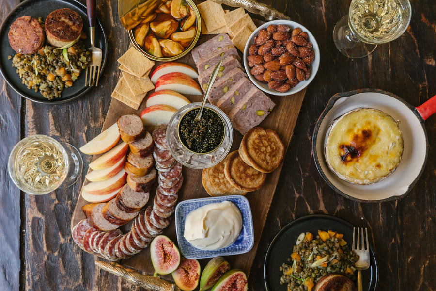 Caviar, charcuterie and pate are the backbones of this board, complete with smoked mussels, almonds, creme fraiche, blinis and two plates with cotechino sausage and lentils. 